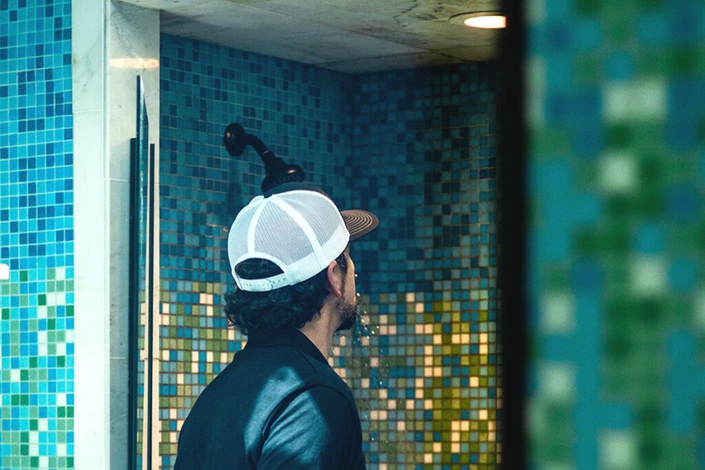 Frame inspector testing a shower for leaks and moisture